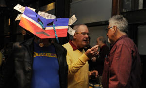 With beads representing Chevron tears, Bill Pinkham of Richmond wears a Chevron symbol mask with fake money taped to it at a party to celebrate the vote